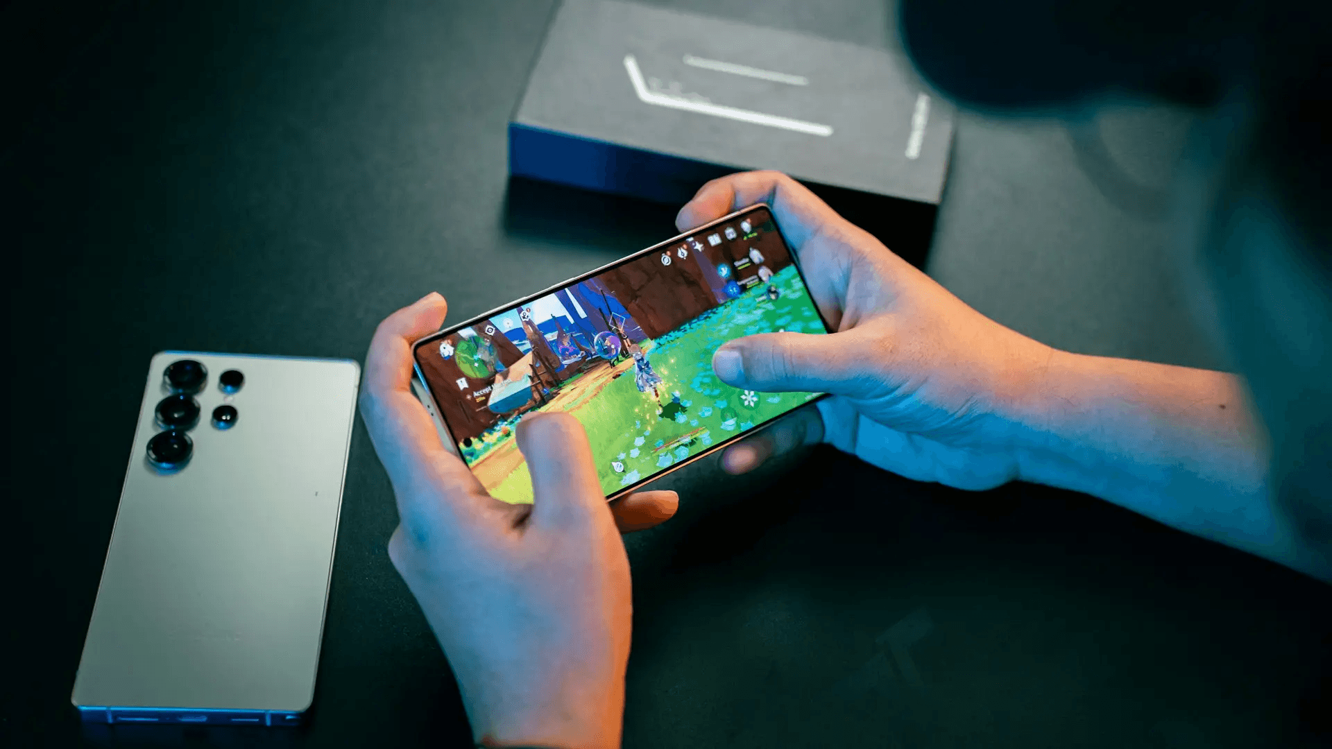 Hands playing a mobile game